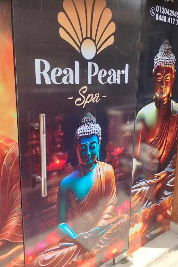Actual glass entryway door with Buddha decal and logo at Real Pearl Spa Noida Sector 31